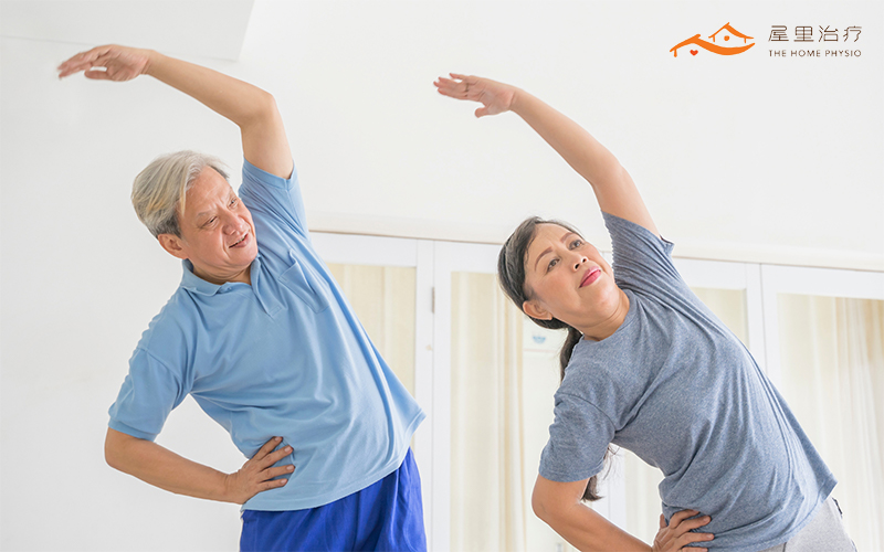 Elderly couple doing stretching exercises