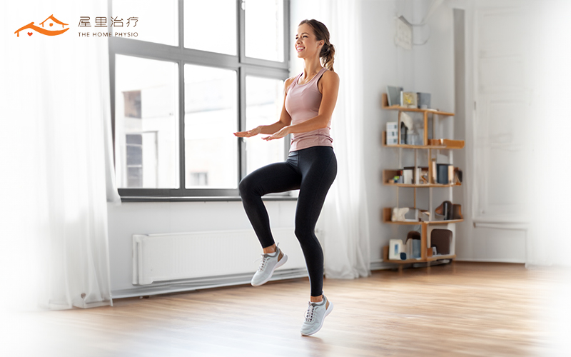 Woman performing a balance exercise indoor.