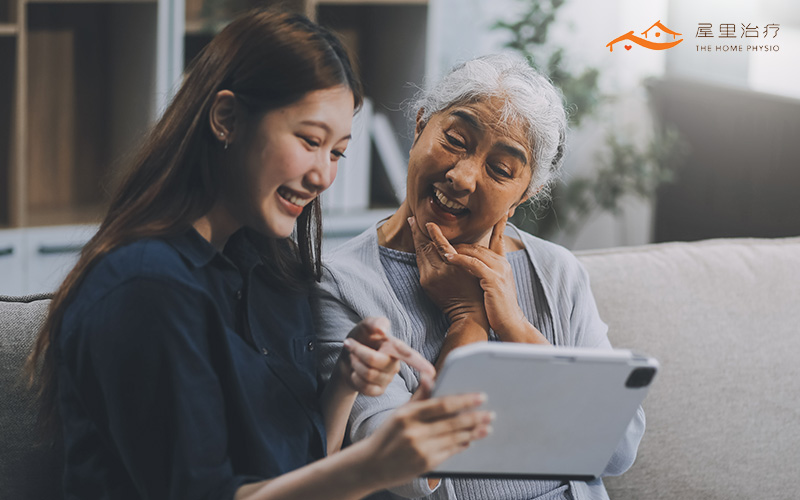 woman showing her tablet to her mother