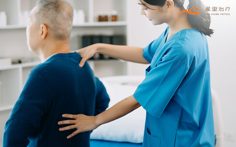 elderly man being helped by physiotherapist
