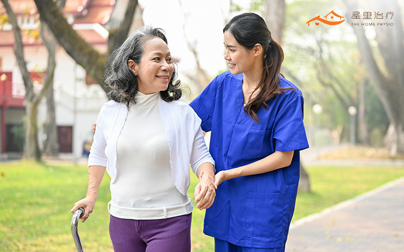elderly woman walking with her caretaker