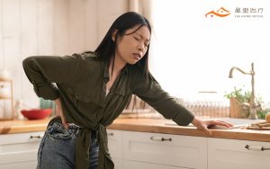 woman holder her lower back in pain