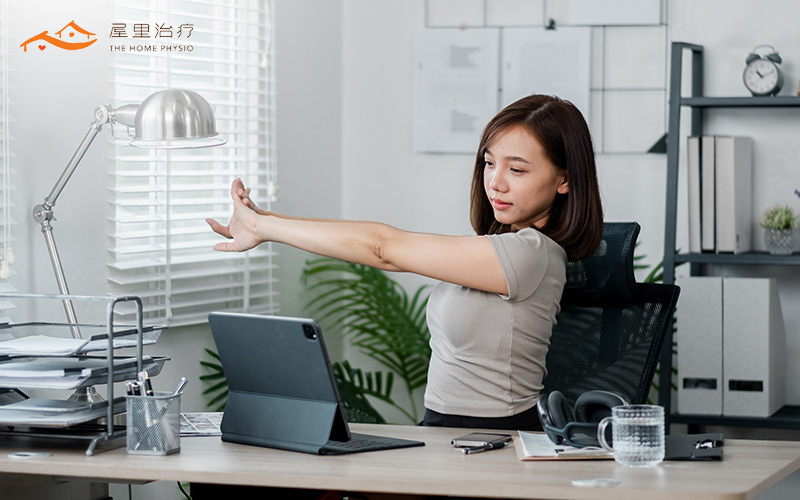 woman stretching her arms in office