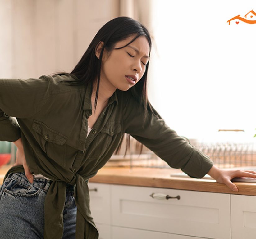 woman holder her lower back in pain